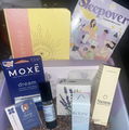 Gift box with skincare products, booklet, and sleepover-themed items.