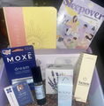 Gift box with skincare products, booklet, and sleepover-themed items.